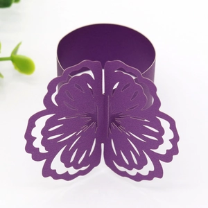 Macro detail of laser-cut floral paper napkin ring in pearlescent purple finish