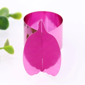 Macro view of metallic magenta pumpkin leaf napkin ring for elegant festive table decor