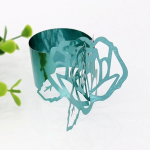Detailed view of the green rose napkin ring with intricate laser-cut metal petals