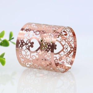 Detailed view of rose gold heart napkin ring with intricate hollowed patterns