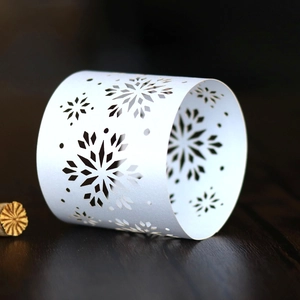 Detailed laser-cut silver snowflake napkin ring with intricate winter holiday patterns
