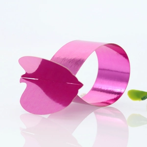 Macro shot of rose pink mirror finish pumpkin napkin ring with a reflective base