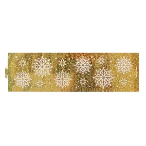 Close-up of golden glitter napkin ring with white snowflake patterns for holiday tables