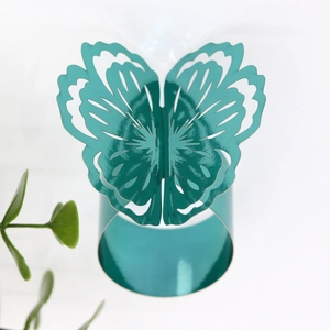 Macro shot of a teal butterfly napkin ring with hollow design for table decor
