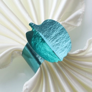 Green leaf shaped napkin ring with metallic mirror finish for festive table decor