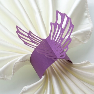 Detailed macro view of laser-cut purple butterfly napkin ring made of pearlescent paper
