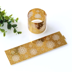 Close-up of golden glitter snowflake napkin rings with laser-cut hollowed design