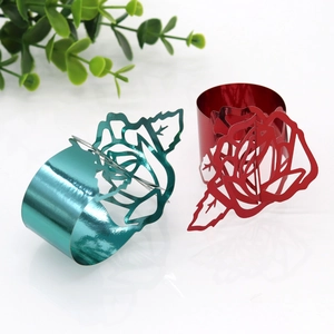 Detailed laser-cut rose napkin ring in vibrant red and teal with a metallic finish