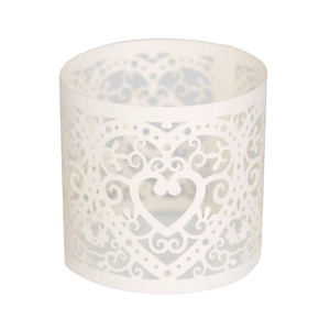 Close-up of laser-cut heart pattern on white paper napkin ring for wedding decor