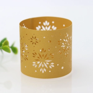 Detailed view of hollow snowflake pattern on golden pearlescent paper napkin ring decor