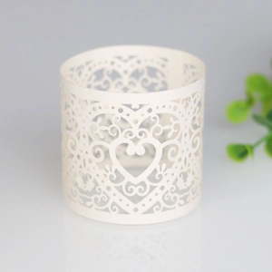 Detailed laser-cut heart pattern on white paper napkin ring for wedding table decor