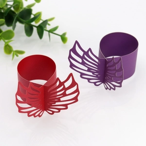 Detail of laser-cut pink paper napkin rings with elegant butterfly wing镂空 patterns