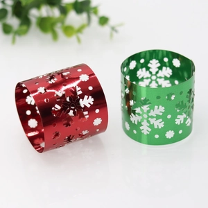 Close-up of red and green snowflake paper napkin rings with mirror finish for Christmas