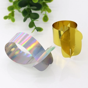 Detail of gold and iridescent silver fruit theme napkin rings with leaf accents