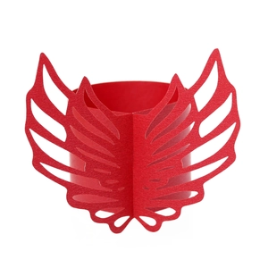 Macro detail of red laser-cut paper napkin ring featuring winged crest design