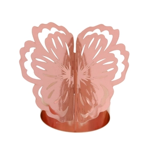 Detailed view of laser-cut rose gold napkin ring with intricate floral butterfly design