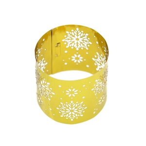 Detailed view of hollow snowflake pattern on golden metal napkin ring holder