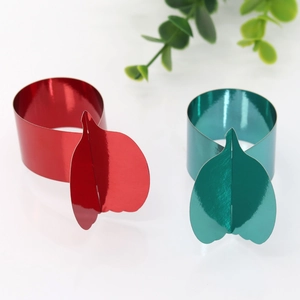 Detail showing red and green pumpkin leaf shaped napkin rings with a glossy finish