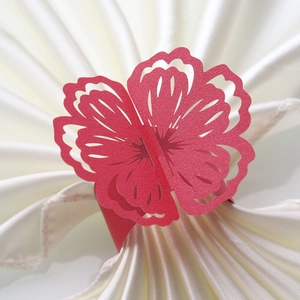 Laser-cut red paper flower napkin ring with layered petals for wedding table decor