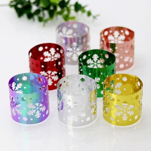 Close-up of laser-cut snowflake napkin rings in six assorted metallic colors for Christmas