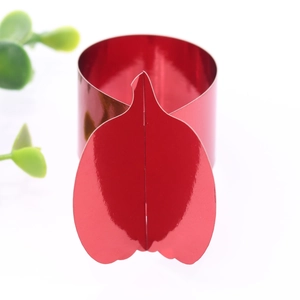 Close-up of a polished red pumpkin shaped metal napkin ring with shiny mirror finish decor