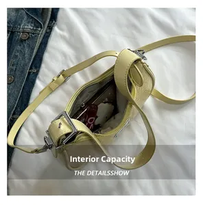 Internal capacity of yellow woven shoulder bag showing phone, lipstick and tissues