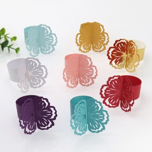 Macro detail of laser-cut paper napkin rings in eight vibrant pearlescent colors