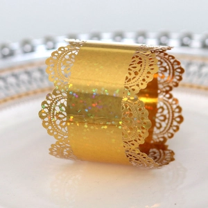 Macro view of golden laser-cut lace napkin ring with sparkling glitter and laser texture