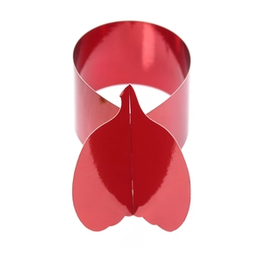 Close-up of metallic red leaf-shaped napkin ring with a polished mirror finish for table decor