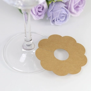 Detailed view of flower-shaped kraft paper wine glass marker with scalloped edges
