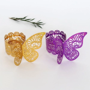 Detail of laser-cut butterfly napkin rings with gold and purple glitter lace finish