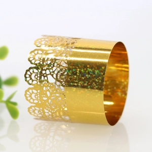 Close-up of golden lace hollow napkin ring with shimmering iridescent glitter detail
