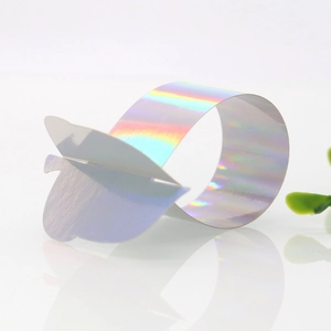 Close-up of laser-cut iridescent butterfly napkin rings with reflective mirror effect