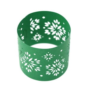 Close-up of green snowflake cutout paper napkin ring for Christmas table decoration