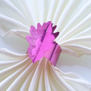 Gros plan détaillé du rond de serviette en forme de feuille rose sur serviette blanche