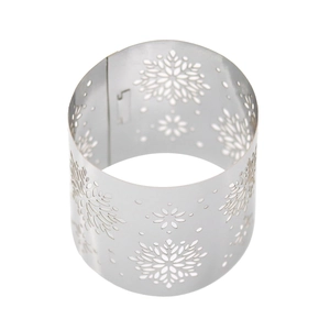 Close-up of silver metal snowflake napkin ring with intricate cutout patterns