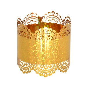 Detail of laser-cut gold lace napkin ring with glittering texture for festive tables