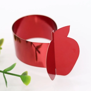Close-up of metallic red apple napkin ring with mirror finish for Thanksgiving