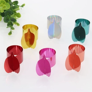 Macro shot of mirror-finish pumpkin napkin rings in six vibrant metallic colors for table decor