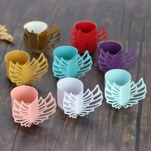 Laser-cut paper napkin rings in diverse vibrant colors with elegant angel wing design