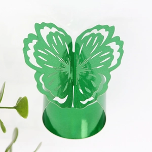 Macro view of bright green glittery butterfly napkin ring with hollow cut-out design