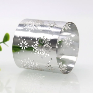 Macro shot of silver hollow snowflake napkin ring with intricate laser cut detail