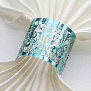 Macro shot of an elegant light blue heart napkin ring with intricate cutout patterns