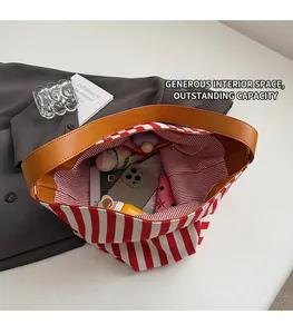 Top view of striped canvas tote bag interior showing large capacity for daily items
