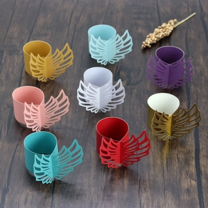 Detailed laser-cut paper napkin rings featuring wing designs in eight assorted colors