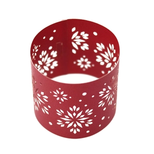 Detail of red laser-cut paper napkin ring with snowflake pattern for Christmas decor
