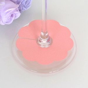Pink petal-shaped wine glass marker on a clear stem base for festive party table settings