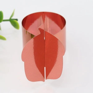 Detail of red metallic fruit leaf napkin ring for Thanksgiving party table decor