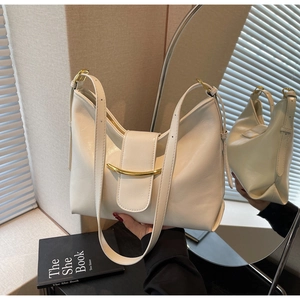 Detail view of cream white PU leather tote with gold hardware and adjustable strap