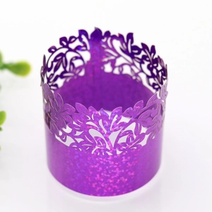 Close-up of purple laser-cut glitter paper napkin ring with floral hollow pattern